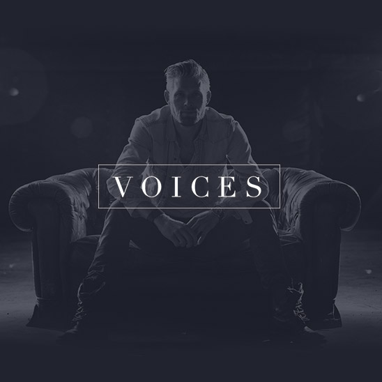 Man seated on sofa with VOICES overlay